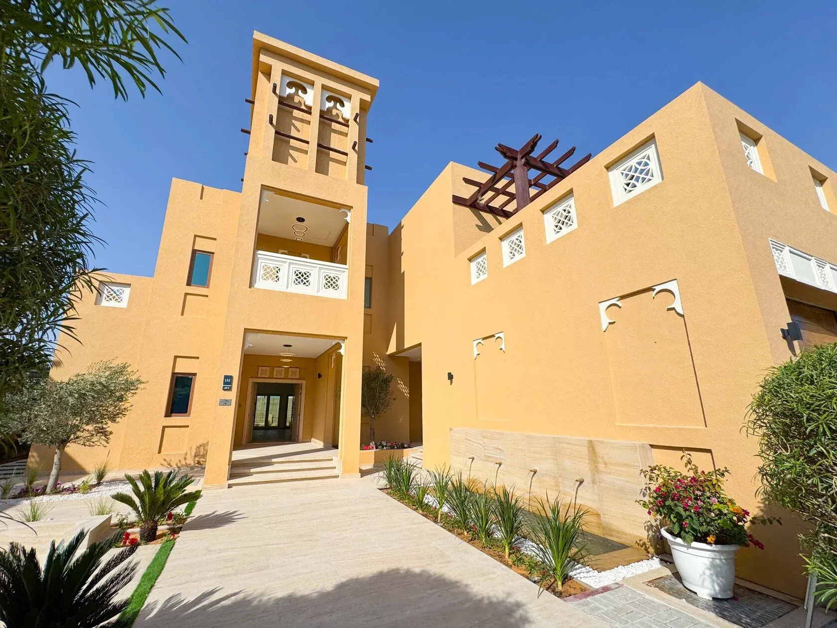 5-Bed Arabian-Style Villa – exterior with wind tower and landscaped entrance
