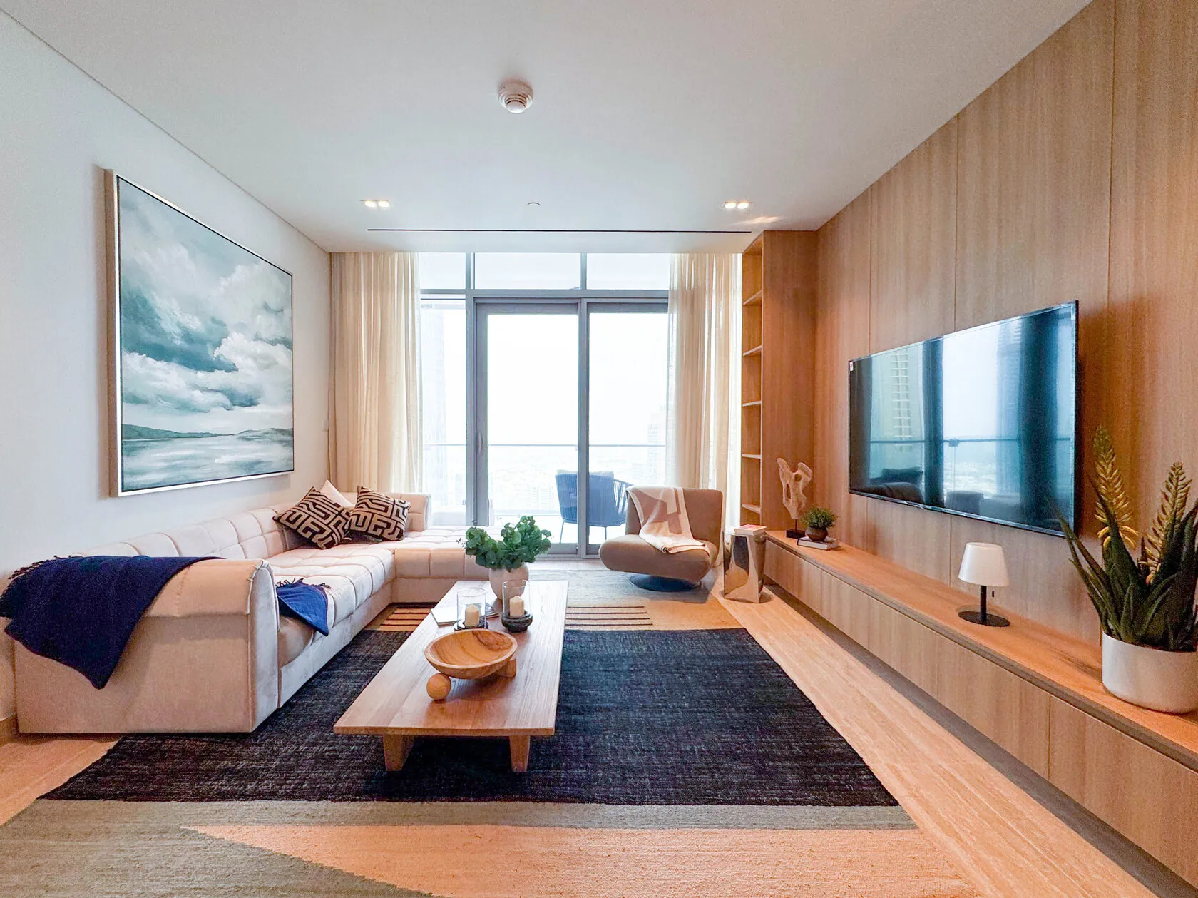 Scandi-Style 1-Bed Apartment – living room with timber TV wall and sea-blue artwork