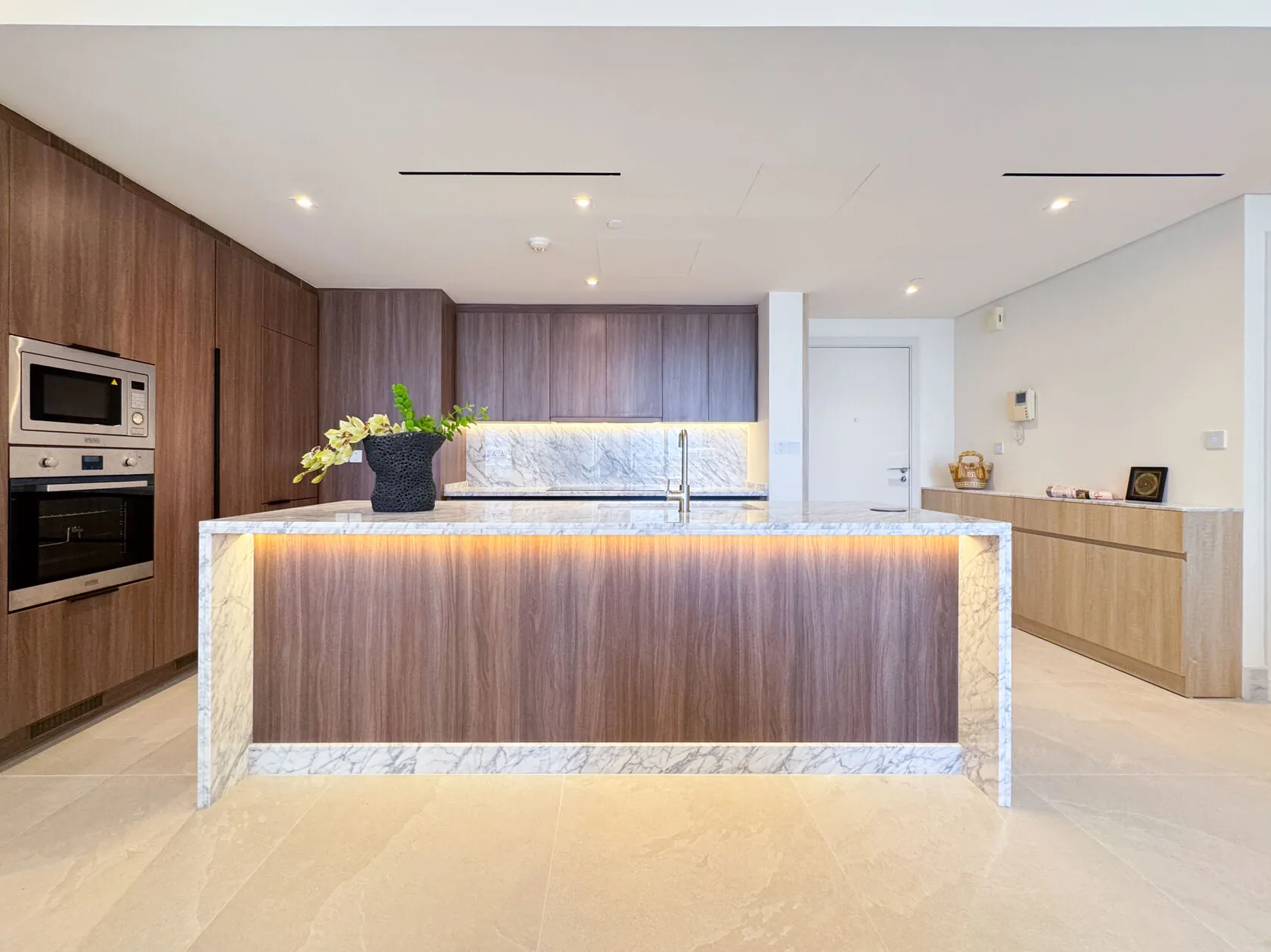 Neo-Modern 2-Bed Apartment – kitchen with walnut island and backlit stone