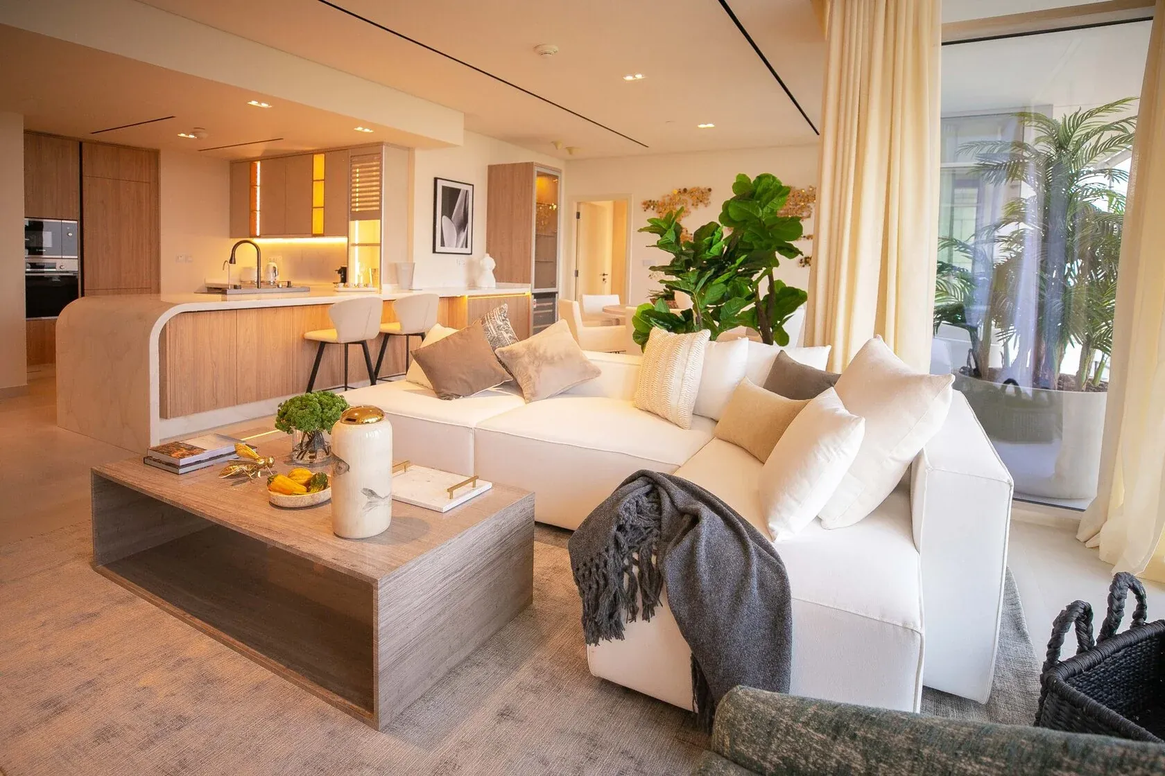Contemporary 3-Bed Apartment – living area with sectional sofa and open kitchen